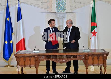 220827 -- ALGIERS, Aug. 27, 2022 -- Algerian President Abdelmadjid Tebboune R and French President Emmanuel Macron attend a signing ceremony in Algiers, Algeria, on Aug. 27, 2022. Algeria and France on Saturday signed a joint declaration for a renewed partnership at the end of the three-day visit of French President Emmanuel Macron. /Handout via Xinhua ALGERIA-ALGIERS-FRANCE-PRESIDENT-VISIT AlgerianxPresidency PUBLICATIONxNOTxINxCHN Stock Photo