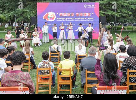 220828 -- BEIJING, Aug. 28, 2022 -- Children folk orchestra perform at the celebration for the 40th anniversary of the founding of the China National Children s Center in Beijing, capital of China, Aug. 27, 2022. A reception for Chinese and foreign guests to celebrate the 40th anniversary of China National Children s Center was held on Saturday. Founded in 1982, China National Children s Center was the first state-level research institution for afterschool education and children s development since the reform and opening up policy was implemented in the late 1970s. Over the past 40 years, the Stock Photo