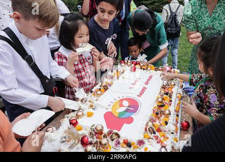 220828 -- BEIJING, Aug. 28, 2022 -- Children enjoy a cake at the celebration for the 40th anniversary of the founding of the China National Children s Center in Beijing, capital of China, Aug. 27, 2022. A reception for Chinese and foreign guests to celebrate the 40th anniversary of China National Children s Center was held on Saturday. Founded in 1982, China National Children s Center was the first state-level research institution for afterschool education and children s development since the reform and opening up policy was implemented in the late 1970s. Over the past 40 years, the center has Stock Photo