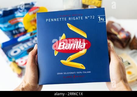 Chicago, USA - 09 07 2023: View of a hand holding a package of Barilla gluten-free spaghetti in a store Stock Photo