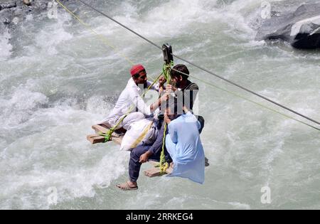 220905 -- SWAT, Sept. 5, 2022 -- Local residents use a temporary cradle service to cross the river Swat after flash floods in Bahrain area of northwest Pakistan s Swat district on Sept. 5, 2022. At least 24 people were killed and 115 others were injured in heavy monsoon rain-triggered flash floods in the last 24 hours in Pakistan, the National Disaster Management Authority NDMA said. Photo by /Xinhua PAKISTAN-SWAT-FLOOD-DAMAGE SaeedxAhmad PUBLICATIONxNOTxINxCHN Stock Photo