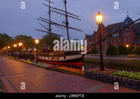 Main canal with sailing ship Friederike von Papenburg in front of town hall in evening light, Papenburg, Emsland, Lower Saxony, Germany Stock Photo