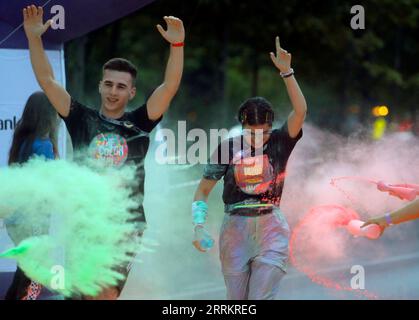 220918 -- BUCHAREST, Sept. 18, 2022 -- Runners are sprayed with colored powder during the Color Run Night fun race in Bucharest, capital of Romania, Sept. 17, 2022. Photo by /Xinhua SPROMANIA-BUCHAREST-COLOR RUN NIGHT CristianxCristel PUBLICATIONxNOTxINxCHN Stock Photo