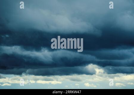 Dark storm clouds with breaking sunlight Stock Photo