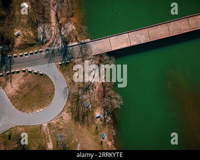 an aerial view of Mansfield Dam with crystal-clear blue water on a sunny day Stock Photo