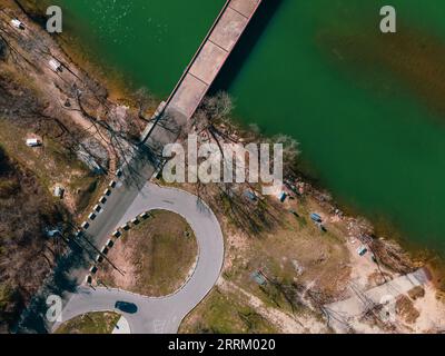 an aerial view of Mansfield Dam with crystal-clear blue water on a sunny day Stock Photo