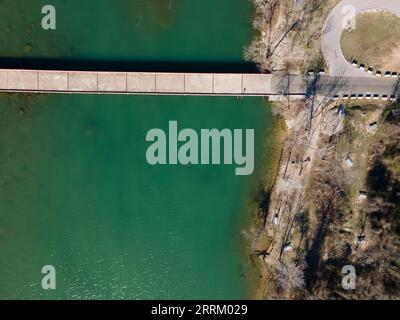 an aerial view of Mansfield Dam with crystal-clear blue water on a sunny day Stock Photo