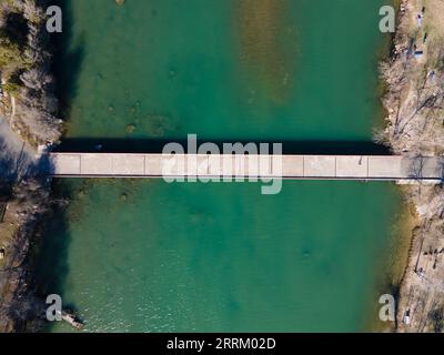 an aerial view of Mansfield Dam with crystal-clear blue water on a sunny day Stock Photo