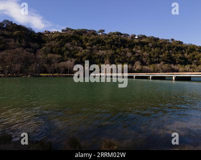 an aerial view of Mansfield Dam with crystal-clear blue water on a sunny day Stock Photo