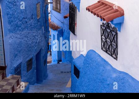 Vibrant blue colored alley in downtown Chefchaouen, Morocco Stock Photo