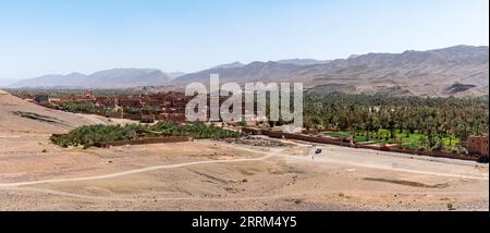 View of Tamenougalt village with its typical clay houses in the Draa valley, Morocco Stock Photo