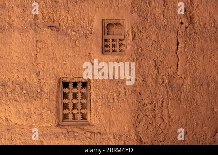 Two little windows in a typical berber house built of clay, Draa valley in Morocco Stock Photo