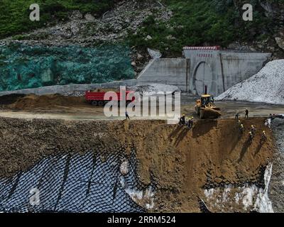 221001 -- LHASA, Oct. 1, 2022 -- Aerial photo taken on Aug. 18, 2020 shows the construction site of the Doxong Pass tunnel exit on the highway linking Pad Township in the city of Nyingchi and Medog County, southwest China s Tibet Autonomous Region. The 67.22-km road connects Pad Township in the city of Nyingchi and Medog County. It is the second passageway to Medog, following the first one connecting the county and Zhamog Township, Bomi County. After the new highway opens to traffic, the length of the road connecting the city proper of Nyingchi and Medog County will be shortened to 180 km from Stock Photo