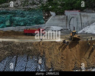 221001 -- LHASA, Oct. 1, 2022 -- Aerial photo taken on Aug. 18, 2020 shows the construction site of the Doxong Pass tunnel exit on the highway linking Pad Township in the city of Nyingchi and Medog County, southwest China s Tibet Autonomous Region. The 67.22-km road connects Pad Township in the city of Nyingchi and Medog County. It is the second passageway to Medog, following the first one connecting the county and Zhamog Township, Bomi County. After the new highway opens to traffic, the length of the road connecting the city proper of Nyingchi and Medog County will be shortened to 180 km from Stock Photo