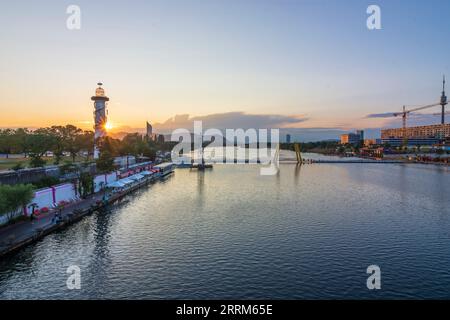 Vienna, river Neue Donau (New Danube), island Donauinsel with lighthouse, Copa Beach, sunset in 22. district Donaustadt, Vienna, Austria Stock Photo