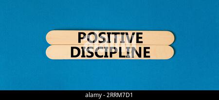 Positive discipline symbol. Concept words Positive discipline on beautiful wooden stick. Beautiful blue table blue background. Business psychology pos Stock Photo