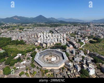 221025 -- CHAOZHOU, Oct. 25, 2022 -- This aerial photo taken on Oct. 21, 2022 shows Daoyun Lou, an octagonal Tulou earthen building compound in Raoping County of Chaozhou, south China s Guangdong Province. Daoyun Lou, China s largest octagonal Tulou earthen building, is undergoing renovations that will give it a new look by June 2023. Daoyun Lou was built in 1587 in today s Chaozhou. In 2006, it became a major historical and cultural site protected at the national level. The walled building compound covers a floor area of 10,000 square meters in the shape of Bagua, or Eight Trigrams, the eight Stock Photo