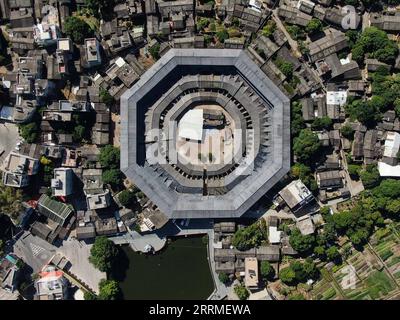 221025 -- CHAOZHOU, Oct. 25, 2022 -- This aerial photo taken on Oct. 21, 2022 shows Daoyun Lou, an octagonal Tulou earthen building compound in Raoping County of Chaozhou, south China s Guangdong Province. Daoyun Lou, China s largest octagonal Tulou earthen building, is undergoing renovations that will give it a new look by June 2023. Daoyun Lou was built in 1587 in today s Chaozhou. In 2006, it became a major historical and cultural site protected at the national level. The walled building compound covers a floor area of 10,000 square meters in the shape of Bagua, or Eight Trigrams, the eight Stock Photo