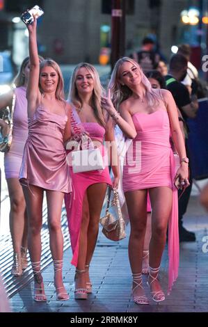 New Street, Birmingham, 8th September 2023 - Revellers hit the streets of Birmingham city centre in the early evening of Friday night as they enjoyed temperatures of 27 degrees. This meant they were able to enjoy wearing light clothing as they made their way from bar to bar. A group of girls dressed pretty in pink posed for a photo as they celebrated a friends 20th birthday. Credit: Stop Press Media/Alamy Live News Stock Photo
