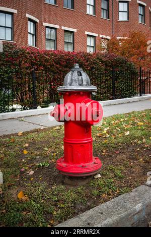 Silver-topped traditional red American style fire hydrant outside a modern housing block on College Street, Burlington, Vermont Stock Photo