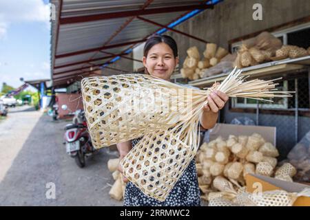 221117 -- BANGKOK, Nov. 17, 2022 -- A staff member shows chaloms in Chiang Mai, Thailand, on Nov. 9, 2022. TO GO WITH Feature: Young Thai designer revives ancient culture through APEC logo design  THAILAND-APEC LOGO DESIGN-CHALOM WangxTeng PUBLICATIONxNOTxINxCHN Stock Photo