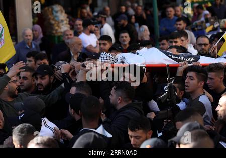 221123 -- NABLUS, Nov. 23, 2022 -- Mourners carry the body of Palestinian teenager Ahmad Shehada during his funeral in the West Bank city of Nablus, on Nov. 23, 2022. One Palestinian teenager was killed, and four Palestinians were injured by Israeli forces during a raid in the West Bank city of Nablus early on Wednesday, the Palestinian Health Ministry said. Photo by /Xinhua MIDEAST-NABLUS-FUNERAL AymanxNobani PUBLICATIONxNOTxINxCHN Stock Photo