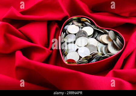Chilean coins in a heart shaped container Stock Photo