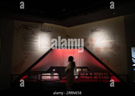 221214 -- HARBIN, Dec. 14, 2022 -- A staff member works at an exhibition hall at the Museum of Evidence of War Crimes by the Japanese Army Unit 731 in Harbin, capital of northeast China s Heilongjiang Province, Dec. 10, 2022. More than 20,000 pieces of artifacts and documents are on exhibit for the first time in a museum in northeast China s Heilongjiang Province, testifying crimes against humanity by the notorious Japanese germ warfare army known as Unit 731 during the World War II. Following a preparation since September, the Museum of Evidence of War Crimes by the Japanese Army Unit 731 in Stock Photo