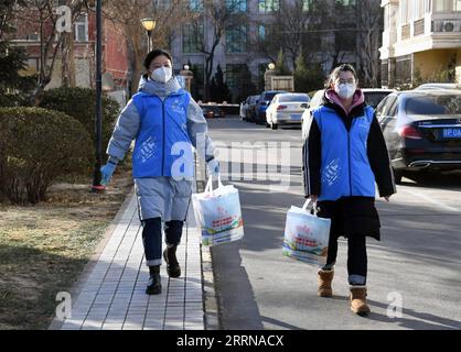 221227 -- BEIJING, Dec. 27, 2022 -- Community workers deliver care packages to senior residents in a community in Yangfangdian Subdistrict of Haidian District in Beijing, capital of China, Dec. 27, 2022. In Yangfangdian Subdistrict, care packages including medicines and COVID-19 prevention materials have been offered for senior residents living alone and those with disabilities. Shared medical kits have also been provided for residents in case of emergency.  CHINA-BEIJING-COVID-19 PREVENTION-CARE PACKAGES CN RenxChao PUBLICATIONxNOTxINxCHN Stock Photo