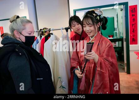 230115 -- OTTAWA, Jan. 15, 2023 -- A visitor learns about the history of Hanfu, traditional Chinese clothing, at the Lunar New Year Market hosted by University of British Columbia UBC Botanical Garden in Vancouver, British Columbia, Canada, on Jan. 14, 2023. The festive event, hosted for the first time by UBC Botanical Garden, features artisan markets and various performances to welcome the Year of the Rabbit. Photo by /Xinhua CANADA-VANCOUVER-UBC BOTANICAL GARDEN-LUNAR NEW YEAR MARKET LiangxSen PUBLICATIONxNOTxINxCHN Stock Photo