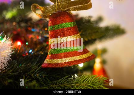 Bell shaped ornament hanging in the Christmas tree Stock Photo