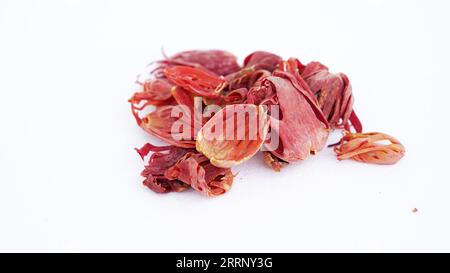 Macro close-up of Organic mace Myristica fragrans on white background. Pile of Indian Aromatic Spice. Stock Photo