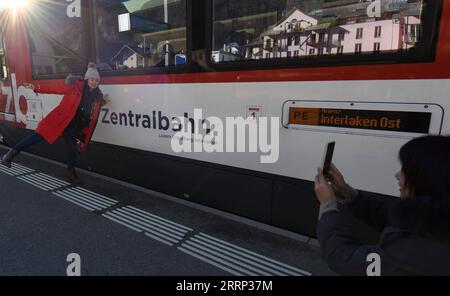 230215 -- GENEVA, Feb. 15, 2023 -- A Chinese tourist poses for a photo with the Zentralbahn from Lucerne to Interlaken during a break in Switzerland, Feb. 14, 2023. A group of 25 people from China visited the city of Lucerne and the popular scenic spot and winter sports resort Jungfrau in central Switzerland on Feb. 13-14, after three years of pandemic-related hiatus. I am very excited to see all these again, said Cui Chenghai, a tourist who frequented Switzerland before the outbreak of the pandemic. It has been three years and everything here has no change, but my feeling is different. Starti Stock Photo