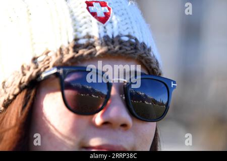 230215 -- GENEVA, Feb. 15, 2023 -- This photo taken on Feb. 14, 2023 shows the snow mountain scenery in the Jungfrau region being reflected on the sunglasses of a Chinese tourist, in Interlaken, Switzerland. A group of 25 people from China visited the city of Lucerne and the popular scenic spot and winter sports resort Jungfrau in central Switzerland on Feb. 13-14, after three years of pandemic-related hiatus. I am very excited to see all these again, said Cui Chenghai, a tourist who frequented Switzerland before the outbreak of the pandemic. It has been three years and everything here has no Stock Photo