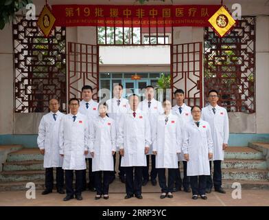 230217 -- BANGUI, Feb. 17, 2023 -- Members of the 19th Chinese medical team dispatched to the Central African Republic pose for a group photo in Bangui, Central African Republic, Feb. 14, 2023. The 19th Chinese medical team dispatched to the Central African Republic arrived in the country in June 2022. Since then, team members have been on China s international medical aid mission here, providing services for local people.  CENTRAL AFRICAN REPUBLIC-BANGUI-CHINESE MEDICAL TEAM LixYahui PUBLICATIONxNOTxINxCHN Stock Photo