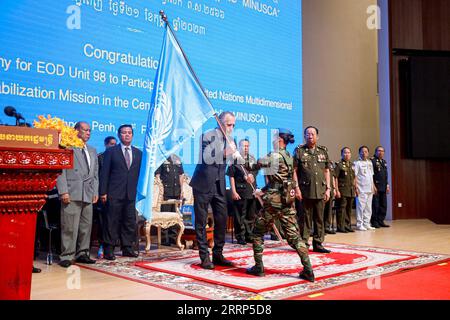 230221 -- PHNOM PENH, Feb. 21, 2023 -- Joseph Scheuer C, United Nations resident coordinator to Cambodia, hands over a UN flag to a Cambodian peacekeeper in Phnom Penh, Cambodia on Feb. 21, 2023. Cambodia on Tuesday dispatched a new batch of 98 peacekeepers to join a United Nations peacekeeping operation in the war-torn Central African Republic, officials said. Photo by /Xinhua CAMBODIA-PHNOM PENH-PEACEKEEPERS-CENTRAL AFRICAN REPUBLIC LyxLay PUBLICATIONxNOTxINxCHN Stock Photo