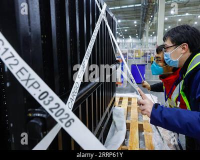 230221 -- CHENGDU, Feb. 21, 2023 -- A staff member and a veterinarian 2nd R examine the Japan-born giant panda Xiang Xiang at Chengdu Shuangliu International Airport in southwest China s Sichuan Province, Feb. 21, 2022. Female giant panda Xiang Xiang on Tuesday morning left Ueno Zoo in Tokyo of Japan to fly back to China, her home country. Xiang Xiang was born at Ueno Zoo in June 2017 to Shin Shin female and Ri Ri male, two giant pandas on loan from China, where the ownership over the cubs they give birth to belongs. Now five years and eight months old, the panda has reached her breeding matur Stock Photo