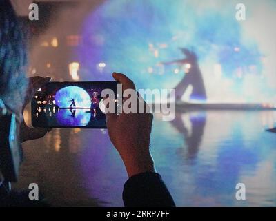 230227 -- LUOYANG, Feb. 27, 2023 -- Tourists watch a film at Luoyi ancient city in Luoyang, central China s Henan Province, Feb. 22, 2023. Official data showed that the city saw 10.31 million trips in January of 2023, generating 6.28 billion yuan about 902.44 million U.S. dollars in revenue, up 746.63 percent and 690.06 percent year on year respectively.  CHINA-HENAN-LUOYANG-CULTURAL AND TOURISM INDUSTRY CN LixAn PUBLICATIONxNOTxINxCHN Stock Photo