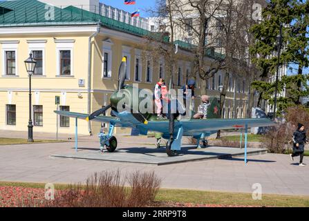 Children in the park climb on a propeller plane of the Second World War. Inscription: 'The LA-7 fighter was produced at the Gorky Aviation Plant in 19 Stock Photo