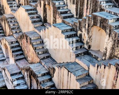 The steps of the Panna Meena ka Kund step well in the city of Amer cascade downwards in a series of geometric patterns. Stock Photo