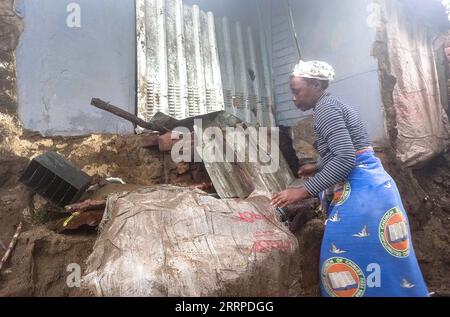 Malawi, Schäden nach Tropensturm in Blantyre 230314 -- BLANTYRE MALAWI, March 14, 2023 -- A woman is seen at a damaged house in Blantyre, Malawi, on March 14, 2023. Tropical Cyclone Freddy has continued to cause devastation in the southern African region as the death toll from disasters such as flash floods and mudslides continues to rise. In Malawi, where the impact of the cyclone looks the most severe, the death toll has risen to 190 as more bodies were found Tuesday following the damages caused by tropical cyclone Freddy, which has now affected 12 districts and cities in the southern Africa Stock Photo