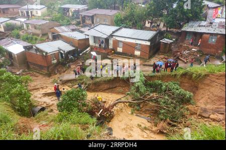 Malawi, Schäden nach Tropensturm in Blantyre 230314 -- BLANTYRE MALAWI, March 14, 2023 -- People gather in an area damaged in floods in Blantyre, Malawi, on March 14, 2023. Tropical Cyclone Freddy has continued to cause devastation in the southern African region as the death toll from disasters such as flash floods and mudslides continues to rise. In Malawi, where the impact of the cyclone looks the most severe, the death toll has risen to 190 as more bodies were found Tuesday following the damages caused by tropical cyclone Freddy, which has now affected 12 districts and cities in the souther Stock Photo