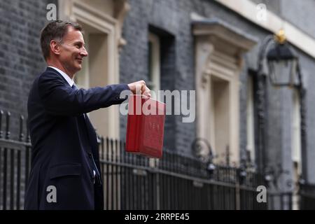 230316 -- LONDON, March 16, 2023 -- Chancellor of the Exchequer Jeremy Hunt of the United Kingdom UK poses for photographs as he leaves 11 Downing Street to deliver his budget to Parliament, in London, Britain, on March 15, 2023. UK on Wednesday unveiled a clutch of measures to boost its struggling economy, including childcare reforms, tax cuts for businesses, and policies to ease the cost-of-living burden for households. /No. 10 Downing Street/Handout via Xinhua BRITAIN-LONDON-JEREMY HUNT-BUDGET RoryxArnold PUBLICATIONxNOTxINxCHN Stock Photo