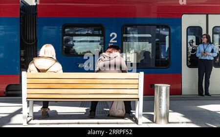 230320 -- NOVI SAD, March 20, 2023 -- Two women sit on a bench waiting for the train at a railway station in Novi Sad, Serbia, on March 19, 2023. The Chinese-built Belgrade-Novi Sad high-speed railway marked its first anniversary on Sunday, having transported nearly 3 million people between Serbia s two largest cities since operation last year. Photo by /Xinhua SERBIA-NOVI SAD-BELGRADE-BUDAPEST RAILWAY-ANNIVERSARY WangxWei PUBLICATIONxNOTxINxCHN Stock Photo