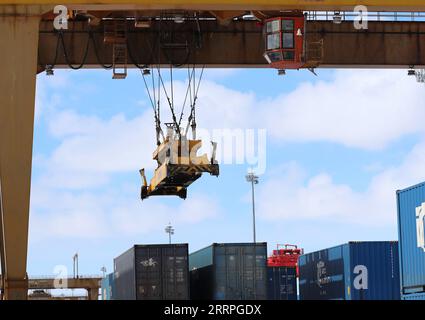 230323 -- MANZHOULI, March 23, 2023 -- This photo taken on March 15, 2023 shows a crane in operation at the container terminal of the Manzhouli Railway Station in Manzhouli, north China s Inner Mongolia Autonomous Region. Located on the eastern corridor of the China-Europe freight train service, Manzhouli, China s largest land port, has witnessed a steady growth of passenger traffic after the resumption of highway passenger transportation here on Jan. 8. Since the beginning of 2023, Manzhouli has handled 924 China-Europe freight trains which carried 97,828 twenty-foot equivalent units TEUs of Stock Photo