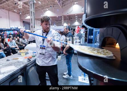 230411 -- TORONTO, April 11, 2023 -- A contestant competes during a pizza competition at the 2023 Restaurants Canada Show RC Show in Toronto, Canada, on April 11, 2023. A total of 30 contestants from across Canada took part in the competition on Tuesday. Photo by /Xinhua CANADA-TORONTO-PIZZA COMPETITION ZouxZheng PUBLICATIONxNOTxINxCHN Stock Photo