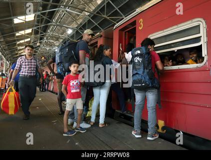 230412 -- COLOMBO, April 12, 2023 -- Passengers board a train before the upcoming Sinhala and Tamil New Year at a railway station in Colombo, Sri Lanka, on April 12, 2023. Sinhala and Tamil New Year is one of Sri Lanka s biggest celebrations. Photo by /Xinhua SRI LANKA-COLOMBO-TRADITIONAL NEW YEAR-TRAVEL RUSH AjithxPerera PUBLICATIONxNOTxINxCHN Stock Photo