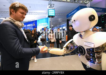 230418 -- HANNOVER GERMANY, April 18, 2023 -- A man shakes hands with an intelligent robot during the Hannover Messe in Hannover, Germany, on April 18, 2023. Germany s leading trade fair for mechanical and electrical engineering kicked off on Monday in Hannover, with the theme of Industrial Transformation - Making the Difference.  GERMANY-HANNOVER-HANNOVER MESSE RenxPengfei PUBLICATIONxNOTxINxCHN Stock Photo