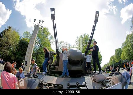 230424 -- BUCHAREST, April 24, 2023 -- Children have fun on an armoured vehicle at a static exhibition of military equipment marking Romanian Land Forces Day at a park in Bucharest, capital of Romania, April 23, 2023. Photo by /Xinhua ROMANIA-BUCHAREST-LAND FORCES DAY-EXHIBITION CristianxCristel PUBLICATIONxNOTxINxCHN Stock Photo