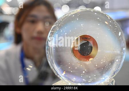 230424 -- HEFEI, April 24, 2023 -- A visitor looks at a lunar soil sample displayed at a Space Day of China science exhibition in Hefei, east China s Anhui Province, April 24, 2023. China celebrated its Space Day this year on Monday with a series of activities and events. A launch ceremony of the Space Day was held Monday in Hefei, capital city of east China s Anhui Province, with this year s theme of Investigate things to extend knowledge, exploring the firmament. About 1,200 guests from over 40 countries are invited to participate in this year s Space Day of China, which includes a series of Stock Photo